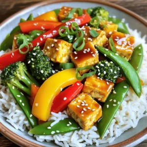 To make this teriyaki tofu stir fry, you will need: - 1 block (14 oz) firm tofu, drained and pressed - 2 tablespoons cornstarch - 2 tablespoons vegetable oil, divided - 1 red bell pepper, thinly sliced - 1 yellow bell pepper, thinly sliced - 1 cup broccoli florets, bite-sized - 1 cup snap peas, trimmed - 3 green onions, sliced diagonally - 4 cloves garlic, minced - 1 tablespoon freshly grated ginger - ½ cup teriyaki sauce (store-bought or homemade) - Sesame seeds, for garnish - Cooked jasmine or brown rice, for serving You can swap out some ingredients if needed: - Use extra firm tofu for a denser texture. - Replace vegetable oil with sesame oil for a nutty flavor. - Try other veggies like carrots or mushrooms for added taste. - Use low-sodium teriyaki sauce for a healthier option. This dish is packed with nutrition. A serving provides: - Calories: Approximately 350 - Protein: 15 grams - Carbohydrates: 45 grams - Fat: 12 grams - Fiber: 6 grams These values may vary based on specific brands and amounts used. This stir fry offers a great balance of protein, carbs, and colorful veggies! If you want to learn how to make this dish, check out the Full Recipe. Enjoy your cooking! First, you need to cut the tofu. Take the block of firm tofu and drain it well. Press it to remove extra water. Then, cut it into bite-sized cubes, about one inch each. This size helps the tofu cook evenly. Next, place the cubes in a bowl. Sprinkle two tablespoons of cornstarch over them. Toss gently until all sides are coated. This coating helps the tofu become crispy when cooked. Now, heat one tablespoon of vegetable oil in a large skillet or wok. Set the heat to medium-high. When the oil is hot, add the coated tofu cubes carefully. Cook the tofu for about 8 to 10 minutes. Stir often until it is golden brown and crispy on all sides. Once done, transfer the tofu to a plate and set it aside. This crispy tofu adds great texture to your stir fry. In the same skillet, add the remaining tablespoon of vegetable oil. Heat it up again. Next, add the sliced red and yellow bell peppers, broccoli florets, and snap peas. Stir-fry these colorful veggies for about 5 minutes. You want them to be tender but still bright and crunchy. This keeps the dish fresh and vibrant. Once the vegetables are ready, add minced garlic and freshly grated ginger. Stir for one more minute to release their amazing aromas. Then, return the crispy tofu to the skillet. Pour half a cup of teriyaki sauce over everything. Toss gently to coat all the ingredients evenly. Cook for another 2 to 3 minutes until everything is heated through. Now, you have a delicious teriyaki tofu stir fry! Garnish with sliced green onions and sesame seeds for extra flavor. Serve it over cooked jasmine or brown rice. This dish is easy and so tasty! For the full recipe, check the recipe section. To make your tofu crispy, start with firm tofu. Press it well to remove excess water. After pressing, cut it into 1-inch cubes. Coat the cubes with cornstarch. This helps achieve that golden brown crust. Heat your skillet or wok until hot. Use enough oil to cover the bottom. Fry the tofu in batches for even cooking. Don’t overcrowd the pan. Let each side cook for about 2-3 minutes. This way, you’ll get a nice crunch on all sides. While teriyaki sauce is key, other ingredients can add depth. Consider adding a splash of rice vinegar for a tangy twist. You can also mix in a teaspoon of sesame oil for a nutty flavor. If you love heat, add sliced chili peppers or a dash of chili flakes. Fresh herbs like cilantro or basil can brighten the dish. For extra crunch, toss in some cashews or peanuts. These additions make your stir-fry even more exciting. Serve your teriyaki tofu stir fry over jasmine or brown rice. The rice soaks up the yummy sauce. You can also serve it with quinoa or noodles for a twist. For a colorful plate, add a side of pickled vegetables. A simple cucumber salad pairs well, too. If you like a bit of spice, serve with sriracha on the side. Garnish with sliced green onions and sesame seeds for a lovely finish. For the full recipe, check out the earlier section. {{image_4}} If you want to change the protein in your stir fry, there are many options. Try chickpeas for a great plant-based choice. You can also use tempeh, which has a nutty flavor. For non-vegetarian options, chicken, shrimp, or beef work well. Each protein brings its own taste and texture. Feel free to mix and match your veggies! Carrots, zucchini, or mushrooms add great flavors. You can also use green beans or bok choy for a fresh crunch. Just remember to cut them into bite-sized pieces to keep cooking easy and quick. The more colors you add, the more fun and healthy your dish will be! Making your own teriyaki sauce is simple and tasty. Here’s a quick recipe: - ½ cup soy sauce - ¼ cup water - 3 tablespoons brown sugar - 1 tablespoon honey or maple syrup - 1 tablespoon cornstarch - 2 tablespoons rice vinegar - 1 teaspoon minced garlic - 1 teaspoon minced ginger To make the sauce, mix all ingredients in a small pot over medium heat. Stir until it thickens, then cool. This sauce adds a personal touch to your teriyaki tofu stir fry, making it even better. You can find the full recipe in the main article. To store your teriyaki tofu stir fry, let it cool down first. Place it in an airtight container. It will stay fresh in the fridge for about 3 to 5 days. Make sure to keep the rice separate if you can. This helps keep the rice fluffy and the stir fry crisp. To reheat, use a skillet over medium heat. Add a splash of water or oil to keep it moist. Heat for about 5 to 7 minutes, stirring often. You can also use a microwave. Just heat it in short bursts of 1 minute, stirring in between. This way, it warms evenly and stays tasty. If you want to freeze your stir fry, put it in a freezer-safe container. Leave some space at the top because it may expand. It can last for up to 3 months in the freezer. When ready to eat, thaw it overnight in the fridge. Reheat it in a skillet or microwave for best results. You can use tempeh or seitan as a tofu substitute. Both options add great texture. Chickpeas also work well if you want a bean-based choice. Just remember to adjust your cooking time to fit the new protein. You want it to be cooked through but still tender. Yes, you can make this dish gluten-free! Use tamari instead of regular soy sauce. Check the teriyaki sauce label too, as some brands contain gluten. You can also make homemade teriyaki sauce using gluten-free ingredients. This way, you can enjoy the same great taste without gluten. For extra heat, add sliced jalapeños or red pepper flakes. You can also include a splash of sriracha sauce while cooking. Adjust the spice level to your taste. Start with a small amount, then increase it if you want more heat. Absolutely! Teriyaki Tofu Stir Fry is vegan-friendly. All the ingredients are plant-based. This makes it a great choice for vegans and vegetarians. Enjoy it without worrying about animal products. You can find the full recipe above to get started! This blog post explored how to make a tasty teriyaki tofu stir fry. We discussed the key ingredients, how to prepare and cook everything, and tips for perfecting your dish. You learned about ingredient swaps, storage, and warming up your leftovers. Remember, you can make this dish your own with different proteins and veggies. Don't hesitate to try new flavors or sauces. Enjoy your cooking journey and have fun with your food!