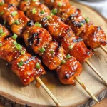 - 1 lb chicken thighs, cut into 1-inch cubes - 3 tablespoons gochujang (Korean red chili paste) - 2 tablespoons soy sauce - 1 tablespoon sesame oil - 2 tablespoons honey - 3 cloves garlic, minced - 1 tablespoon fresh ginger, minced - 2 green onions, finely chopped (reserve some for garnish) - 1 tablespoon sesame seeds (for garnish) - Wooden skewers (soaked in water for 30 minutes prior to use) The main ingredients form the heart of this dish. Chicken thighs bring juicy flavor. Gochujang adds a bold kick. Soy sauce gives it a savory touch. Sesame oil adds a nutty aroma. You also need extra ingredients to enhance the taste. Honey balances the heat with sweetness. Garlic and ginger pack in fresh flavor. Chopped green onions add crunch and color. Sesame seeds make for a lovely garnish. Don't forget the skewers! Soaking them in water prevents burning on the grill. This step is key for perfect skewers. You can find the full recipe at the end of this article. Enjoy cooking your Korean BBQ chicken skewers! Start by making your marinade. In a large bowl, mix together the gochujang, soy sauce, sesame oil, honey, minced garlic, minced ginger, and finely chopped green onions. Stir until everything is well combined. This marinade brings a sweet and spicy flavor to your chicken. Next, add the cubed chicken thighs to your marinade. Make sure each piece is well coated. Cover the bowl with plastic wrap and place it in the fridge. Let it marinate for at least 30 minutes. If you want stronger flavors, let it sit for up to 2 hours. Now it’s time to grill. Preheat your grill or grill pan to medium-high heat. While it heats up, thread the marinated chicken cubes onto the skewers. Leave a little space between each piece. This helps them cook evenly. Once your grill is hot, place the skewers on it. Grill the chicken for about 10-15 minutes. Turn them often for a nice char. Use a meat thermometer to check the internal temperature. It should reach 165°F. This ensures your chicken is safe to eat and juicy. For best flavor, marinate chicken for at least 2 hours. This allows the chicken to soak up all those tasty spices. If you can, marinate overnight. The longer you wait, the better the flavor. Use medium-high heat to achieve the perfect char without burning. This temperature helps cook the chicken evenly. Flip the skewers often for nice grill marks and to avoid charring. Keep an eye on the time; it should take about 10 to 15 minutes. Garnish with sesame seeds and green onions for a lovely touch. These add a nice crunch and fresh taste. Consider serving with a dipping sauce like extra gochujang or soy sauce. It makes each bite even more fun. {{image_4}} You can easily swap chicken for other proteins. Beef, pork, or tofu work well too. Each option brings its own taste. For beef, use tender cuts like sirloin. For pork, consider shoulder or loin. Tofu gives a nice vegetarian spin. Just ensure any protein you choose is cut into similar sizes for even cooking. To add a fun twist, try adding pineapple chunks or bell pepper pieces. These ingredients boost taste and sweetness. Pineapple adds a tropical flair, while bell peppers offer crunch and color. You can place these between the chicken pieces on the skewers. This adds variety and makes each bite exciting. If you like heat, you can adjust the gochujang amount. More gochujang makes the skewers spicier. If you prefer mild flavors, reduce the gochujang or use less. You can also add chopped fresh chili for a different heat level. Feel free to customize it to match your taste. Keep uneaten skewers in an airtight container in the refrigerator. This keeps them fresh. You can enjoy them later without losing flavor. They will stay good for about three days. Don't forget to label the container with the date! Reheat on the grill or stovetop for the best results. This method brings back the char and flavor. If you use a microwave, be careful. It can make the chicken rubbery. Heat on medium until warm, turning often for even heat. Freeze marinated chicken before grilling for future meals. This is a great way to save time. Place the chicken in a freezer-safe bag, removing as much air as possible. It can last for up to three months in the freezer. When you're ready to cook, just thaw in the fridge overnight. This method keeps the flavors locked in, ready for a tasty meal. For the best flavor, marinate the chicken for at least 30 minutes. However, I recommend marinating for up to 2 hours. This extra time allows the marinade to soak deep into the chicken. The gochujang, soy sauce, and honey create a wonderful blend of sweet and spicy. You can use wooden skewers without soaking, but I do not recommend it. If you skip soaking, the skewers may burn on the grill. Soaking helps prevent them from catching fire. To soak, just place them in water for about 30 minutes before grilling. Korean BBQ chicken skewers pair well with many side dishes. Here are some great options: - Steamed rice or fried rice for a filling side. - Kimchi for a tangy, spicy kick. - Cucumber salad for a refreshing crunch. - Grilled vegetables to add color and nutrition. You can find the full recipe for Korean BBQ Chicken Skewers [here](#). It's packed with flavors and easy to follow! This post covered how to make delicious Korean BBQ chicken skewers. I shared key ingredients, marination steps, and grilling techniques. You learned tips for perfecting flavor and ideas for variations. Don't forget that storing leftovers or freezing extra chicken can save you time. Embrace these flavors and share this recipe with friends. Cooking can be simple and fun. Enjoy every bite you create!